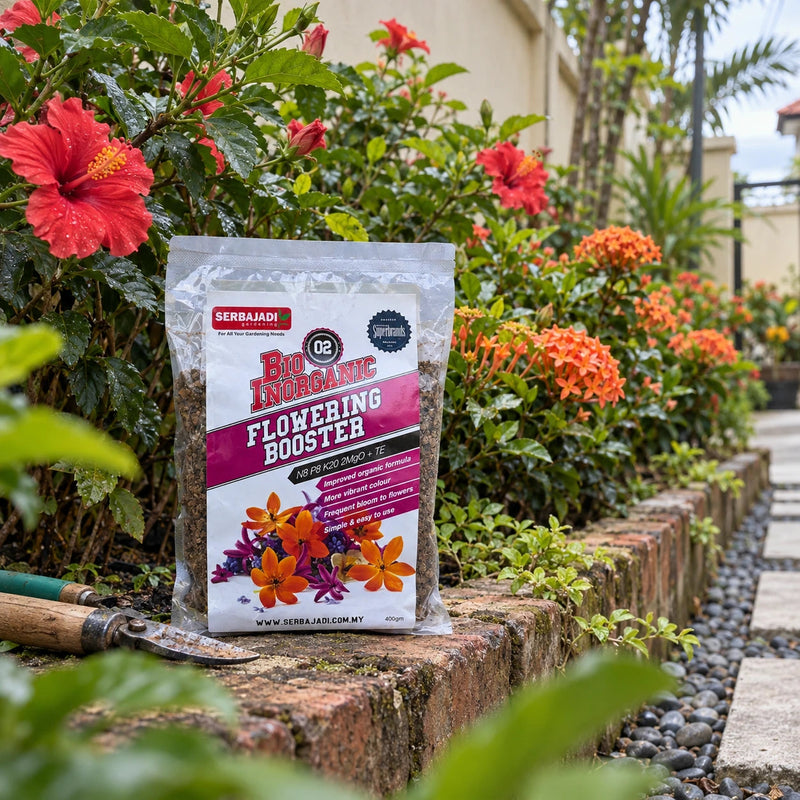 Serbajadi Bio-Inorganic Flowering Booster 02 beside flowering plants in a garden.